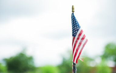 US flag waves proudly, representing the nation's history, unity, freedom, and patriotism. Its stars symbolize the states, while the stripes represent valor and resilience