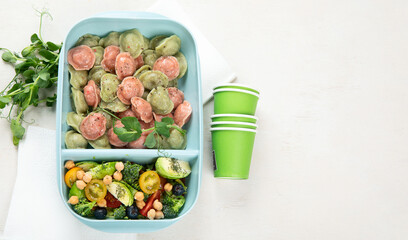 Vegetarian food. Colored dumplings in a plate/on board.