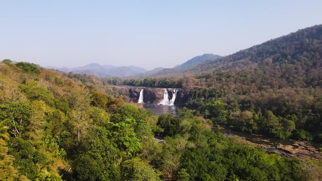 Flying Towards Athirappilly Water Falls With Dense Vegetations In Chalakudy Taluk Of Thrissur District In Kerala, India. Aerial Drone Shot