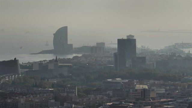 evening smog barcelona city central district famous bay hotel aerial panorama 4k spain
