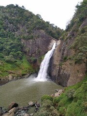 Obraz premium Dunhinda Waterfall is a popular tourist attraction in Sri Lanka near Badulla. It stands at about 64 meters and is surrounded by beautiful greenery. 