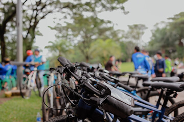 A number of bicycles are parked neatly at the Sentul roundabout during a leisurely cycling event on a sunny morning	

