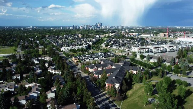 Drone side shot of downtown Calgary in summertime with rainy clouds