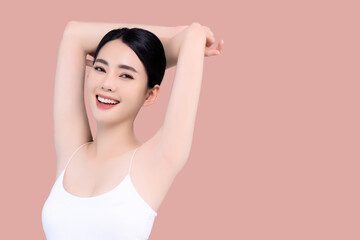 Beautiful young Asian girl lifting hand up to shows off clean and clear armpit or underarms isolated on pink background, Smooth and freshness armpit concept. - obrazy, fototapety, plakaty