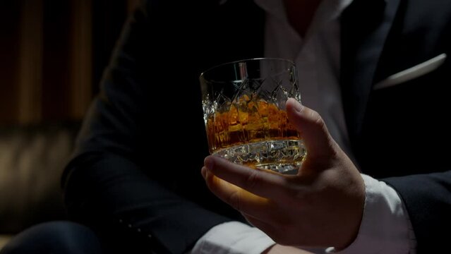 businessman holding whiskey, a restaurant