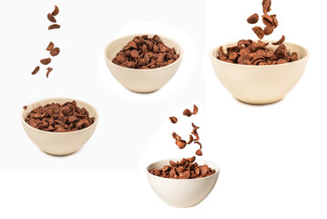 Chocolate corn flakes falling to the white bowl isolated on white. Motion.