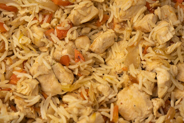 Tasty pilaf with chicken as background.