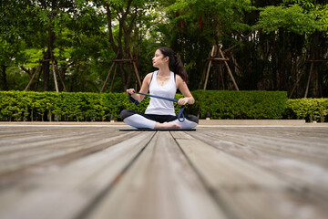 Young female on a wooden bridge in the park with healthy yoga activities