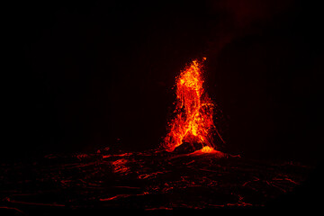 Lava erupting. Night view of Halemaʻumaʻu from Kilauea Overlook  June 2023. Kīlauea Caldera. Hawaiʻi Volcanoes National Park.

