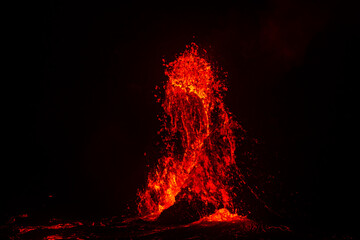 Lava erupting. Night view of Halemaʻumaʻu from Kilauea Overlook  June 2023. Kīlauea Caldera. Hawaiʻi Volcanoes National Park.


