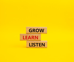 Grow Learn Listen symbol. Concept words Grow Learn Listen on wooden blocks. Beautiful yellow background. Business and Grow Learn Listen concept. Copy space