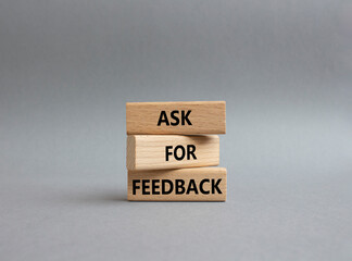 Feedback symbol. Concept word Ask for feedback on wooden blocks. Beautiful grey background. Business and Ask for feedback concept. Copy space