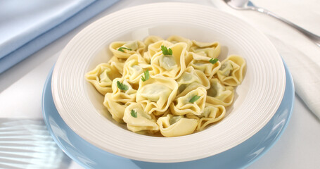 tortelloni on a plate. classic italian pasta with spinach and ricotta on a light background. dish of mediterranean cuisine. food on the table on a sunny day.