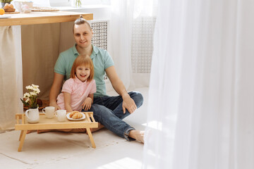 Father and daughter having breakfast in the morning. High quality photo.