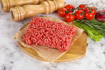 Raw minced beef meat on cutting board