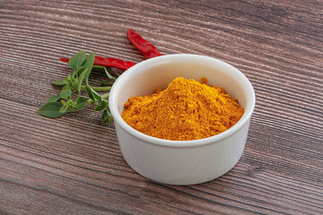 Yellow vibrant curcuma powder in the bowl