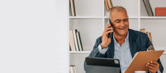 Fototapeta premium mature man with mobile phone working in the office