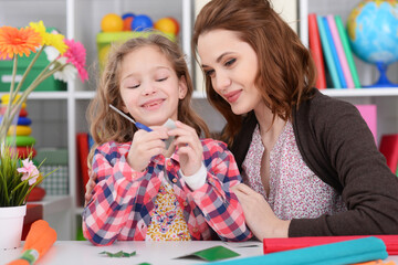 Mother teaches kid to do craft items