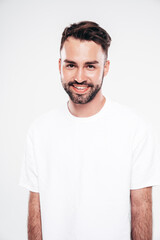 Fototapeta premium Portrait of handsome smiling stylish hipster lambersexual model. Sexy man dressed in white T-shirt and jeans. Fashion male isolated on white background in studio