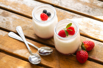 natural yogurt with strawberries on wooden background