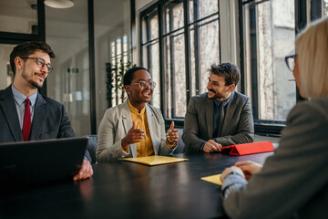 Shot of group of business persons in business meeting. Entrepreneurs on meeting in board room talking with a job candidate. - obrazy, fototapety, plakaty