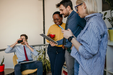 Group of businesspeople using technology together.