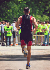 Male runner in sports gear at the finish line