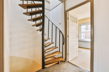 the inside of a house with wood and metal staircase leading up to an open door that leads to...