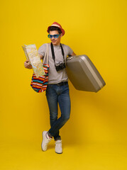 Traveller ready for journey, isolated on vibrant yellow background. The image showcases traveller...