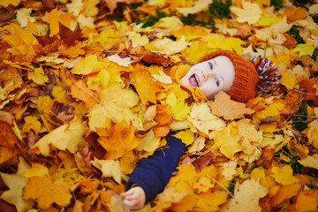 Adorable preschooler girl enjoying nice and sunny autumn day outdoors
