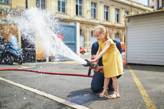 Adorable preschooler girl acting like a fireman