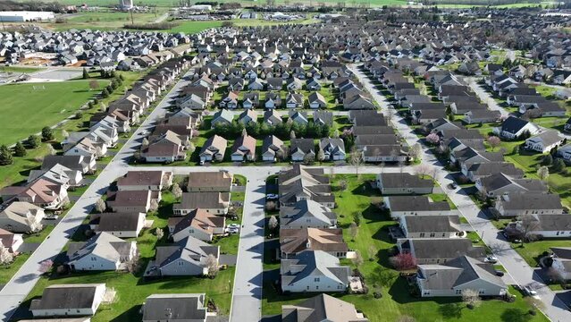 A beautiful establishing shot of a residential area of the USA. Houses and homes in sprawling neighborhood during spring.