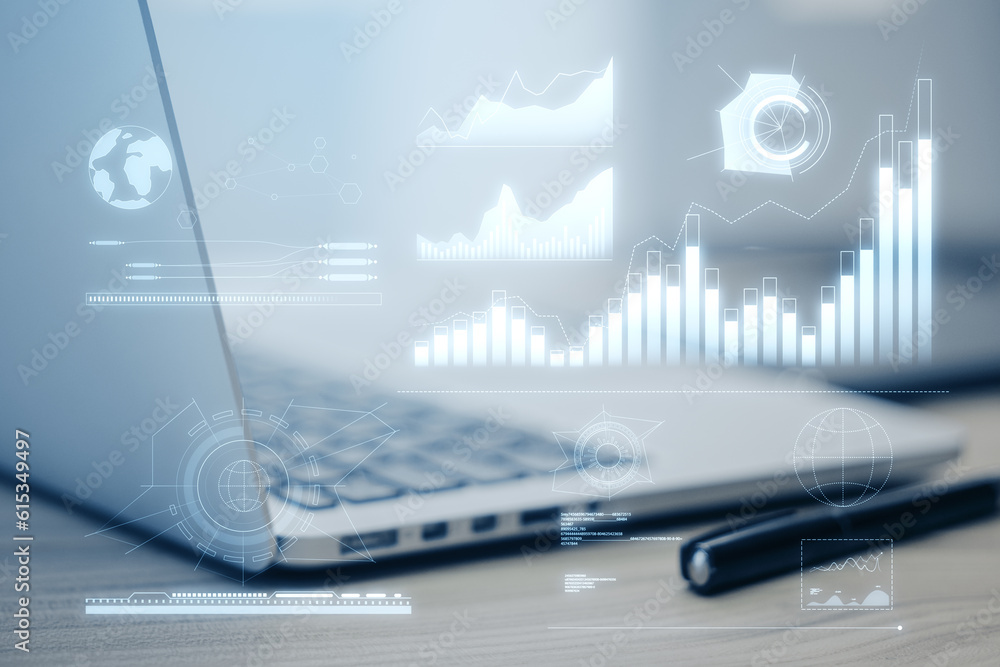 Poster close up of laptop computer on wooden desk with pen and business charts hologram on blurry backgroun