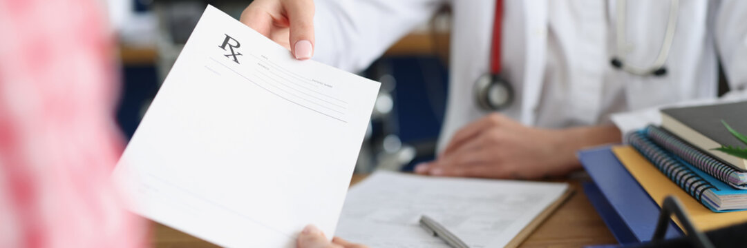 Doctor giving a drug medical prescription to patient in clinic. Prescribing pills by therapist cardiologist concept