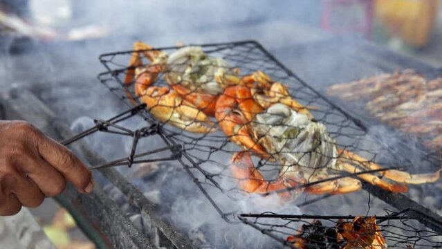 Cooking Asian Street Food from Seafood on Market. Fried Street Food on Traditional Asia Grill. Authentic Cook Shef Make Crabs and Shrimp on Fat Oil. Gastronomic Cuisine in World. Cook Man Close-up 4k