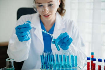 Modern medical research laboratory. female scientist working with micro pipettes analyzing...