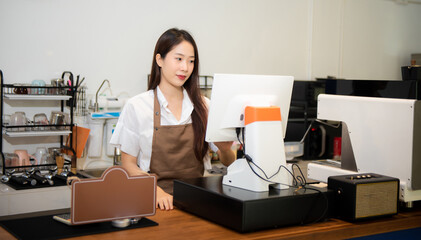 Young woman coffee shop owner holding notepad and digital tablet ready to receive orders in cafe restaurant. woman barista cafe