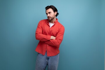 pensive young brunette man in red shirt