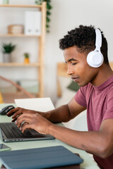 Man works with concentration on his laptop at home.