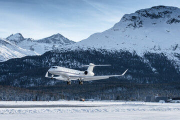 Luxury private jet approaching the engadin valley in the Swiss alps. This mountain resort is...