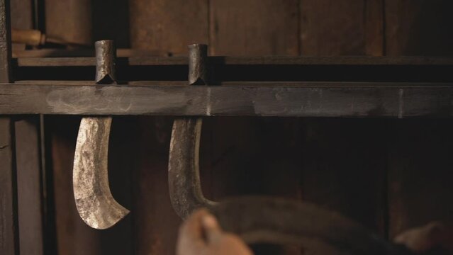antique iron knife is inserted into the wooden wall of an old wooden house.