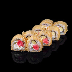 Fried sushi roll on a dark background. Restaurant with Japanese cuisine.