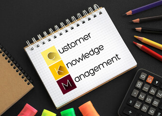 CKM - Customer Knowledge Management acronym on notepad, business concept background