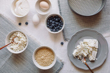 Ingredients for making cheesecake or pie with blueberries, top view, copy space.