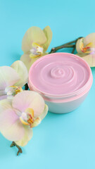 Cream cosmetic container and orchid flower, copy space