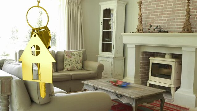 Animation of hanging golden house keys against interior of a living room