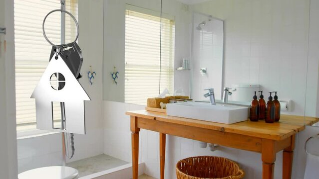 Animation of hanging golden house keys against interior of a modern bathroom