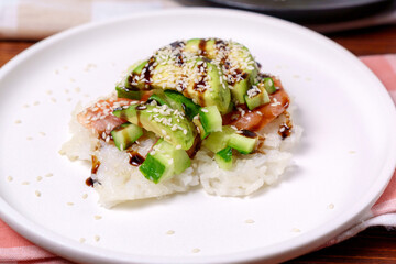 Sushi Waffles food trend, made with a crispy rice waffle and topped off with salmon, cucumber, and avocado.