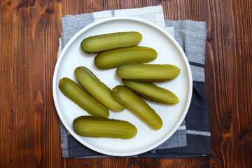 Pickled cucumbers close-up, snack. Selective focus. Ingredients for cooking on a wooden table