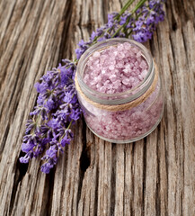 Fototapeta na wymiar Lavender flowers on wooden background with lavander salt. Top wiew